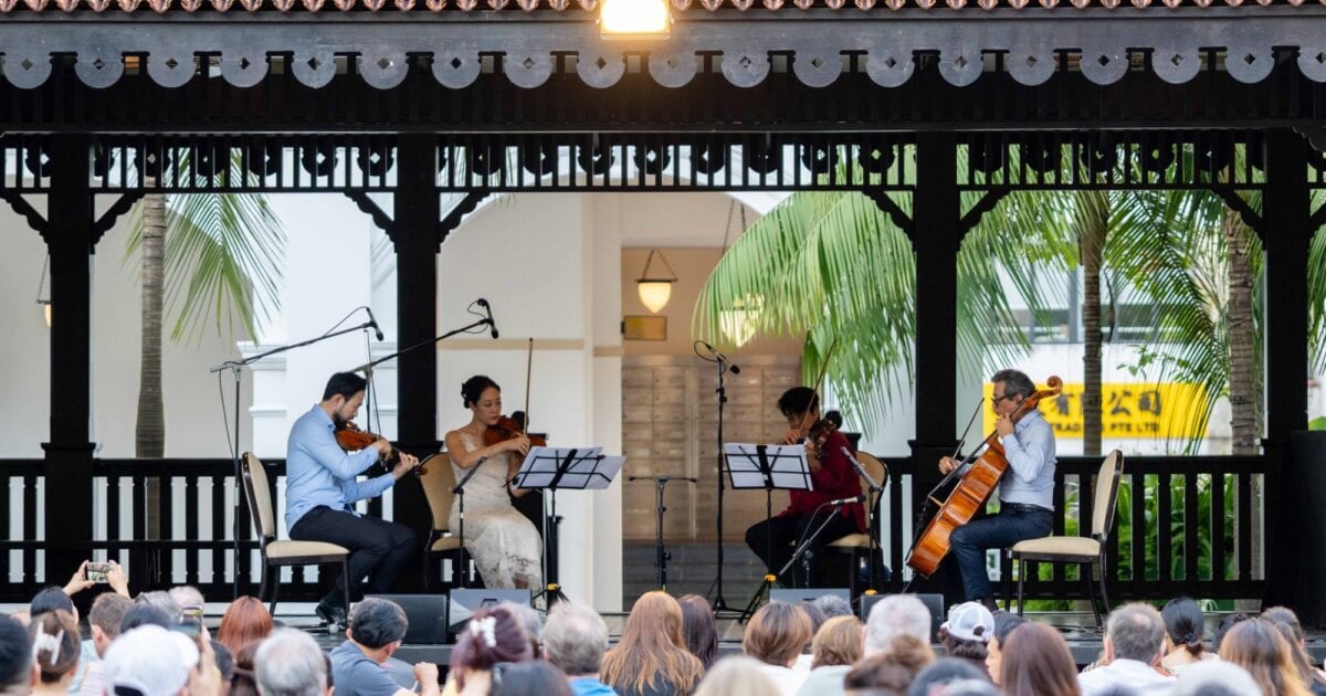 String quartet performing on the lawn at Raffles Hotel
