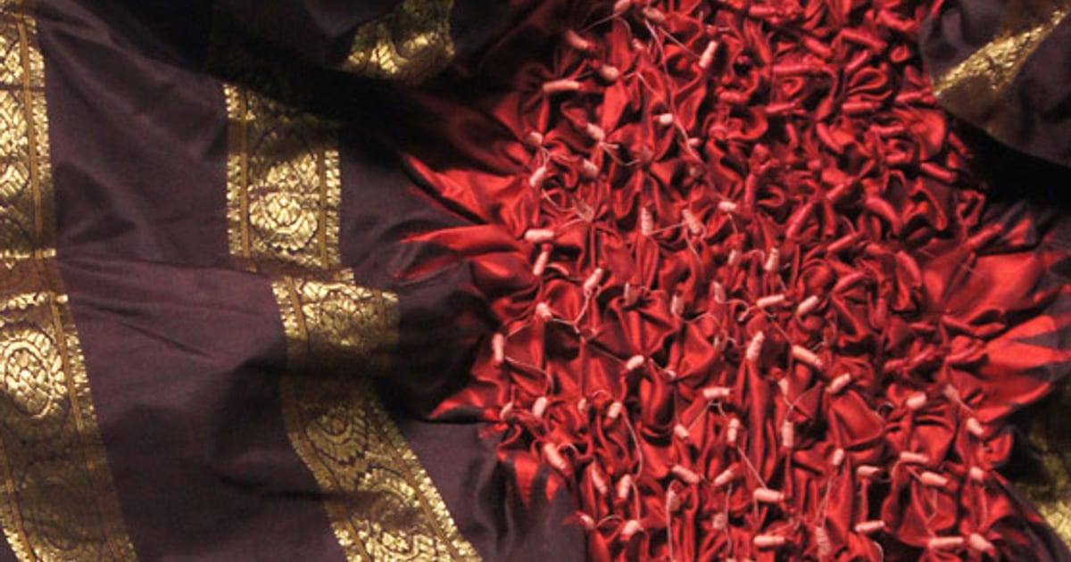 Detail of stitched red cloth from The Saree Project